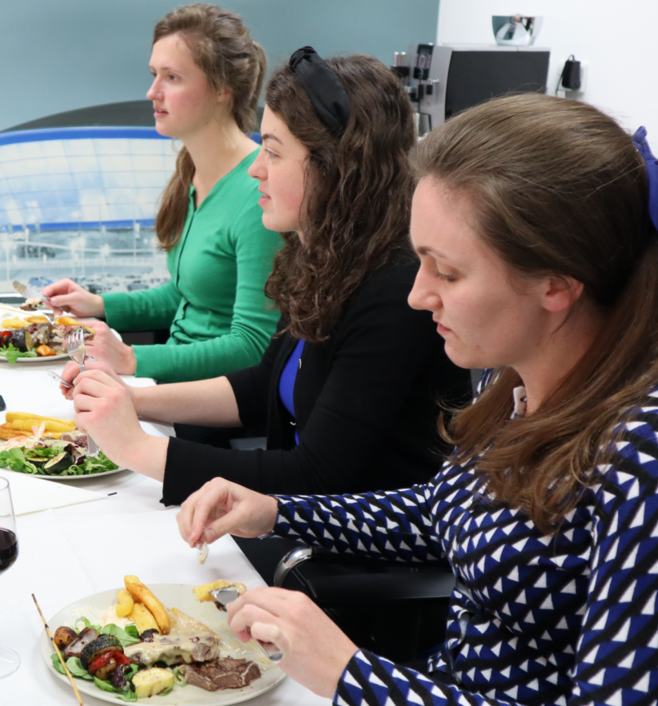 Members of the team eating the meal