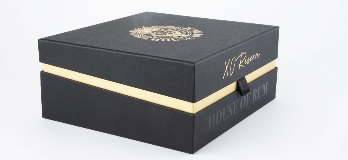 A black and gold box that is used for luxury packaging to enhance sales for product launches.