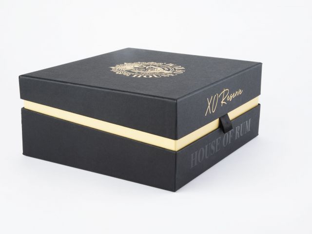 A black and gold box that is used for luxury packaging to enhance sales for product launches.