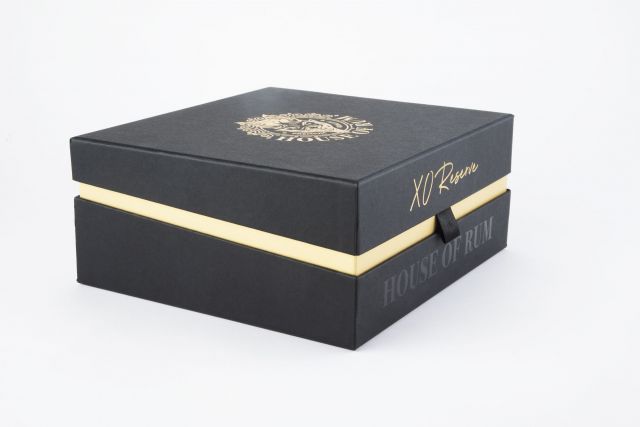 A black and gold box that is used for luxury packaging to enhance sales for product launches.