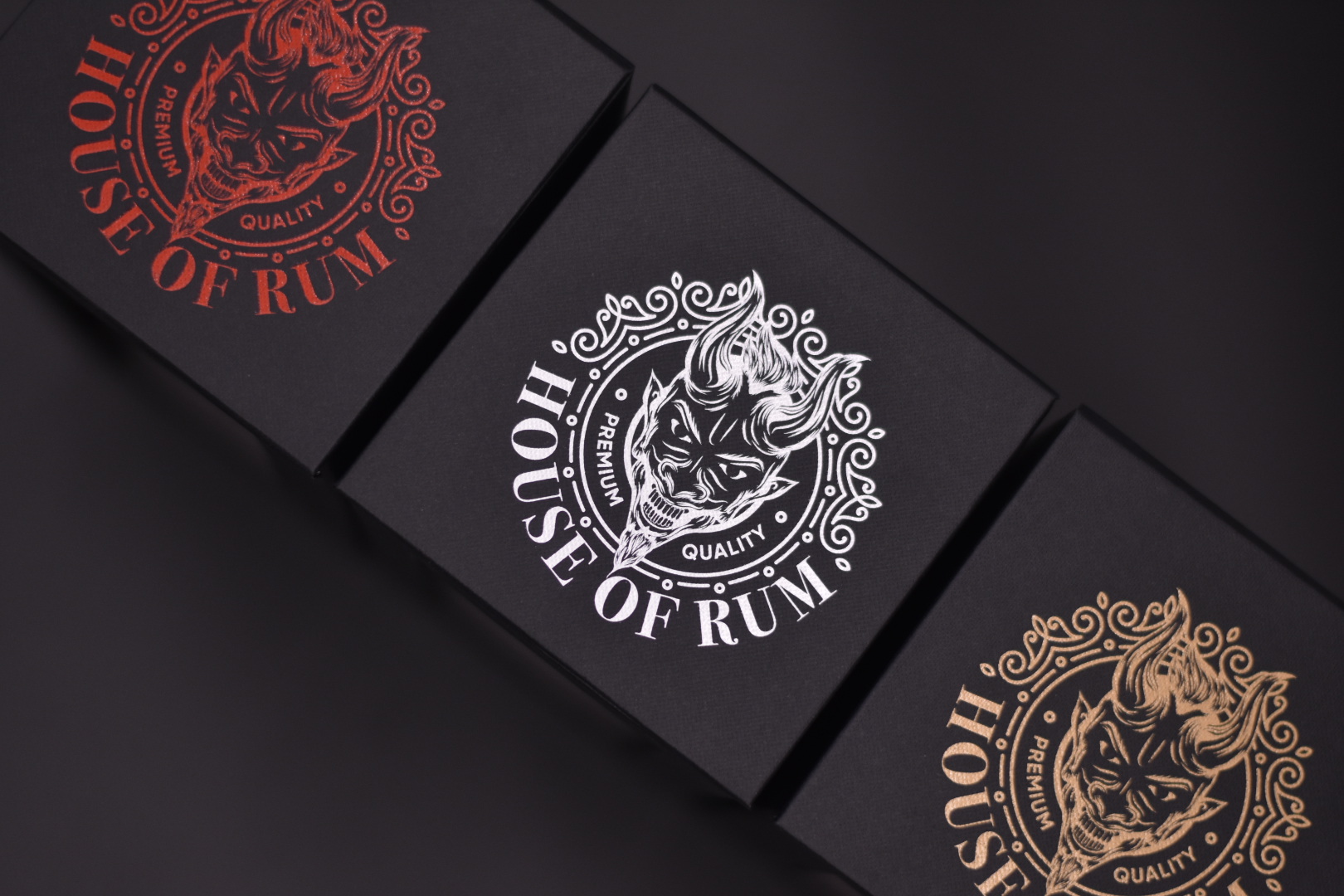 Close up of the house of rum packaging with three logo colours to show their bespoke rigid boxes