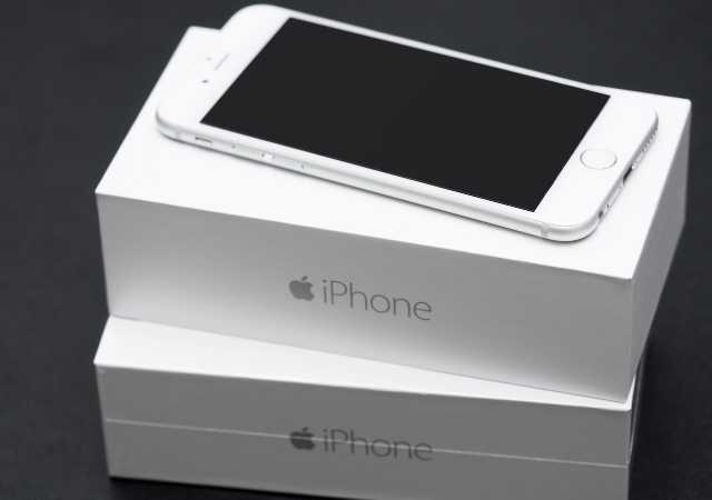 A close up of an iphone and its packaging to show how the packaging is just as important as the product.